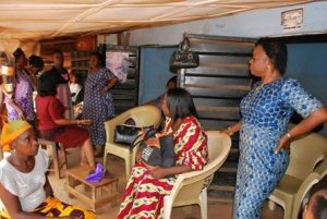 Women seated and standing in a room during a stallholders training session