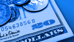 Close-up of a United States twenty dollar note with coins resting on it, tinted blue.